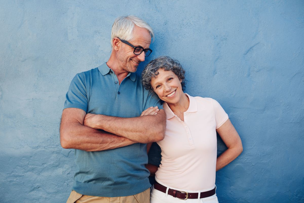 Smiling  mature woman standing with her husband