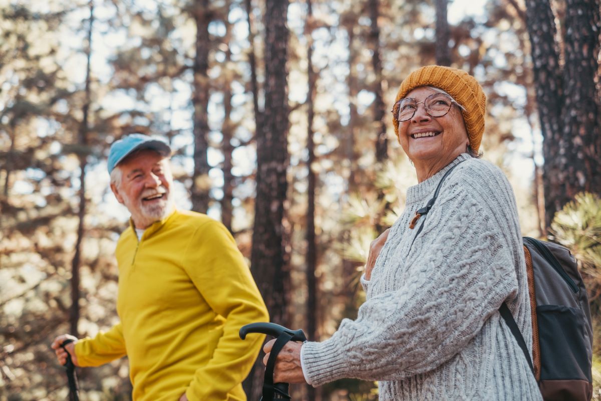 Close up head shot of a cheerful smiling senior woman walking with her husband
